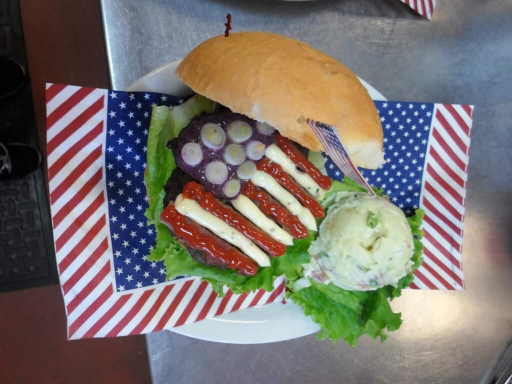 A hamburger decorated to look like an American flag.