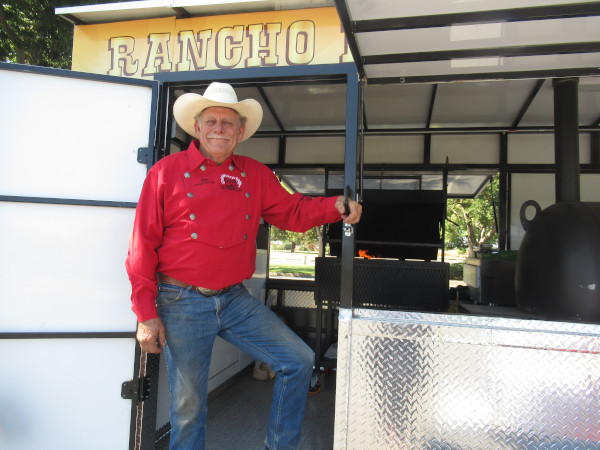 Jim Brown poses at the door to his mobile bbq trailer.