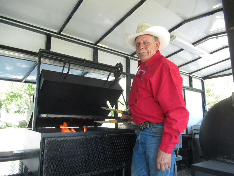Jim Brown operates a BBQ grill.